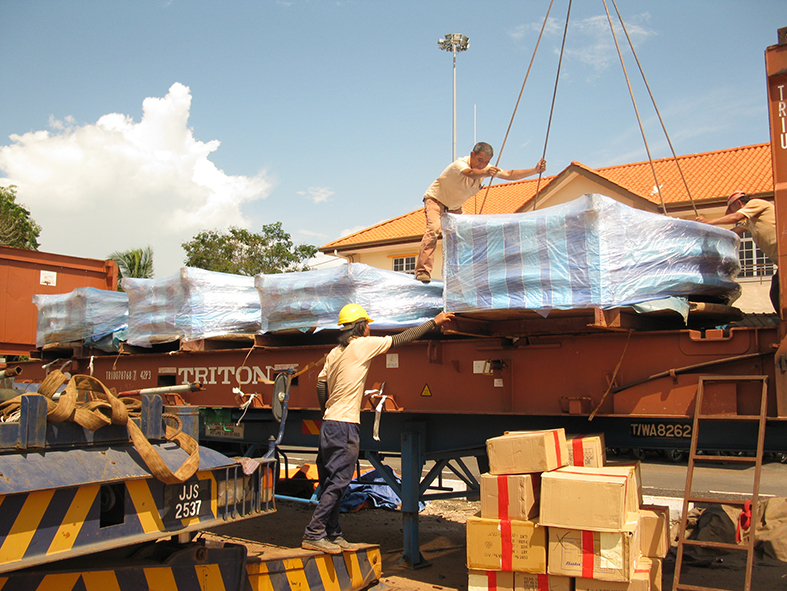 Popular Pack workers make sure cartons are arranged and secured.
